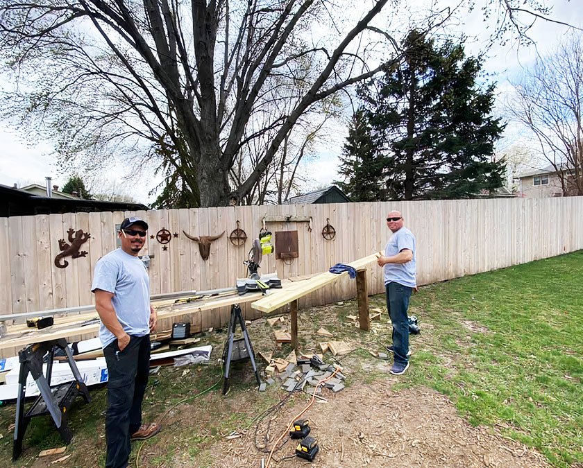 Team staff preparing wooden boards for custom deck building.