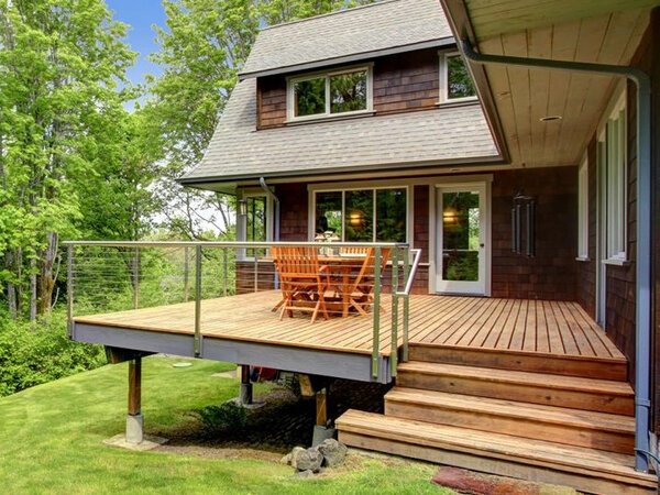 an elevated deck on a steep patch of grass