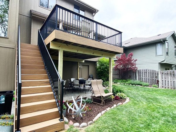 Unstained deck stairs with black railing