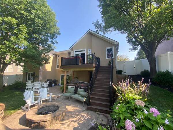 An elevated deck with stairs and railing