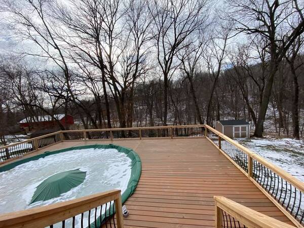 A wood deck with a pool