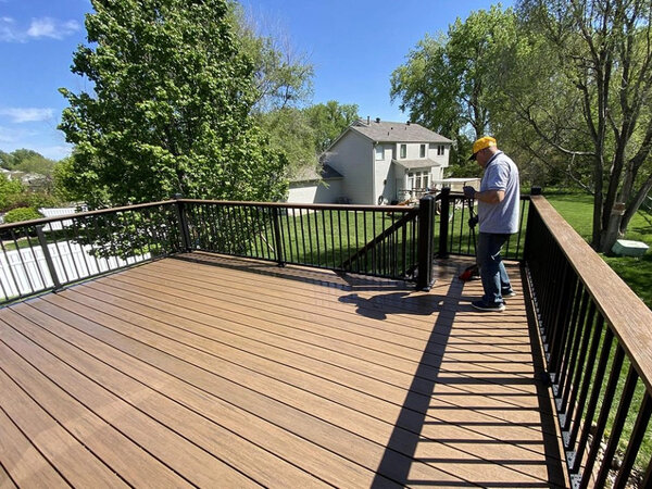 A man working on fixing a deck