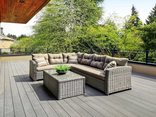 Top photo of a large gray deck with furniture
