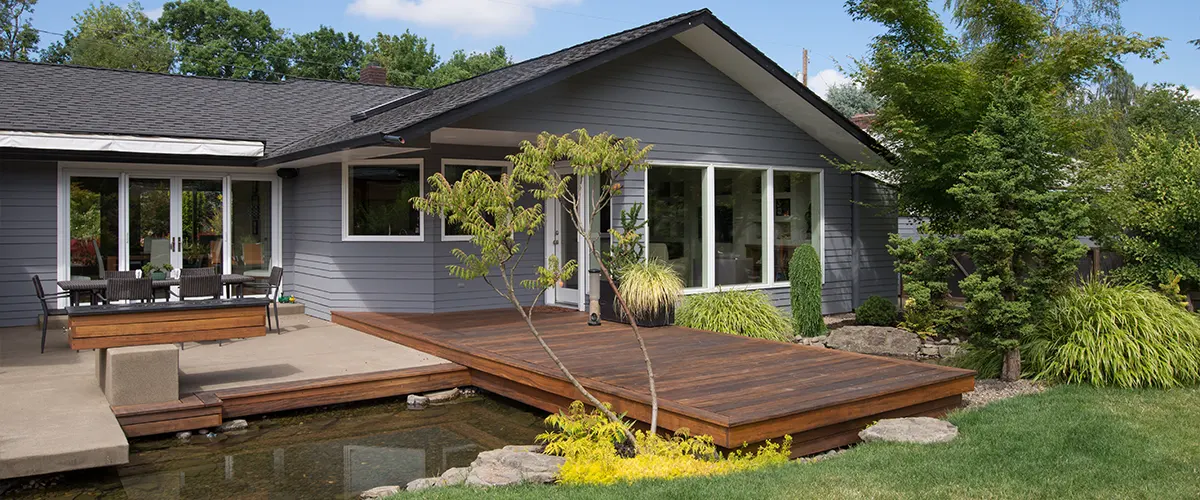 A small deck with a pond and a small tree