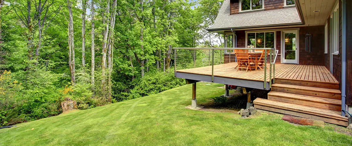 An elevated deck with stairs and railing