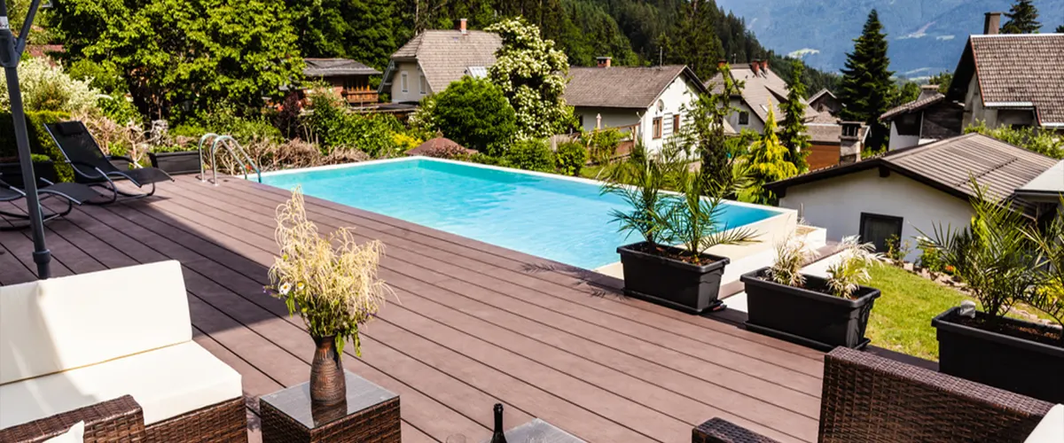 A composite deck with a large pool and plants