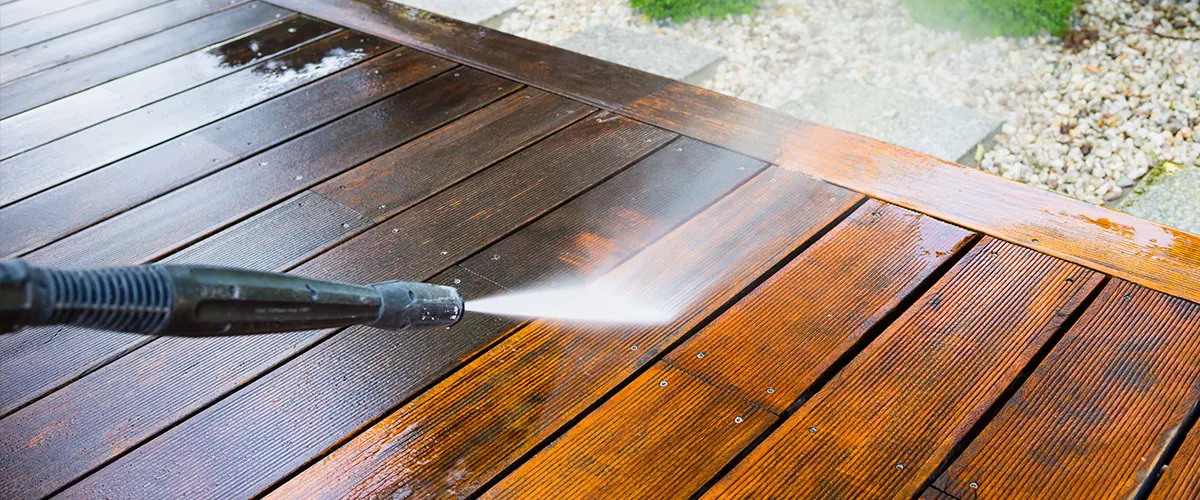 A composite deck being pressure washed