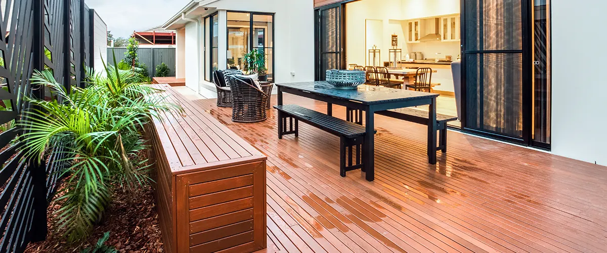 Cool composite deck with a black table near a glass door