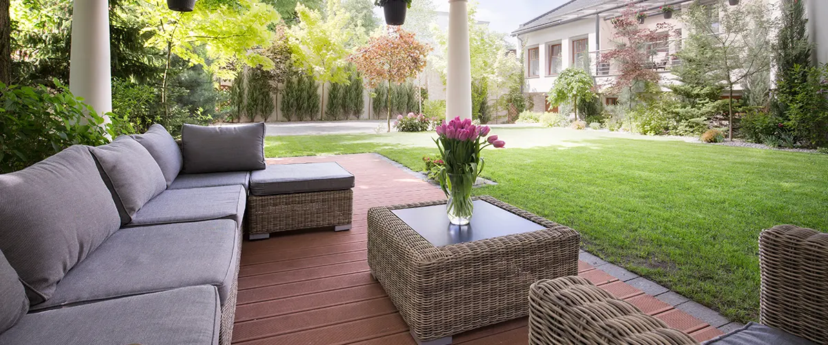 backyard deck with benches and green grass