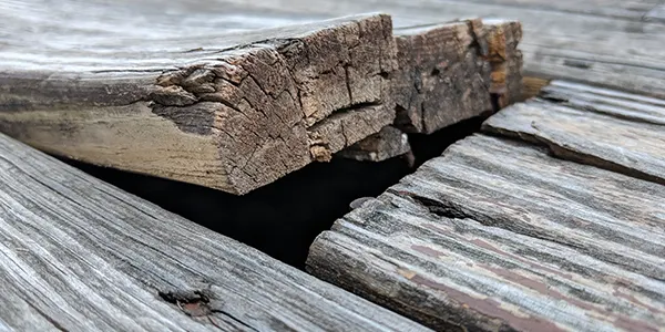 A warping wood board on a deck