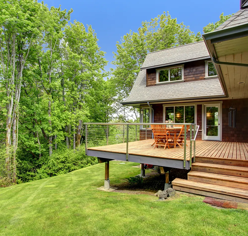 An elevated deck on a steep patch of grass