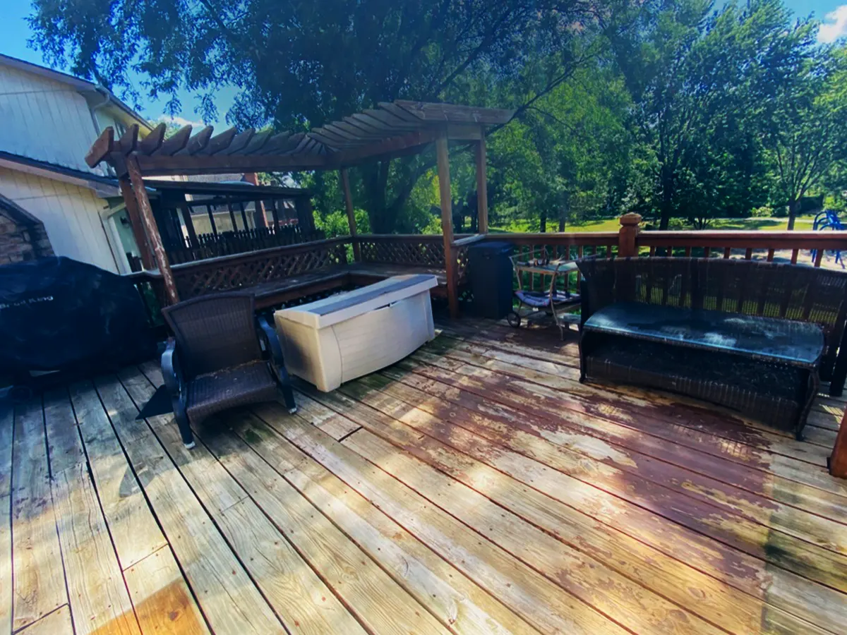 An old deck with black chairs