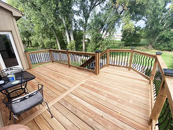 A wood deck with metal and wood railing