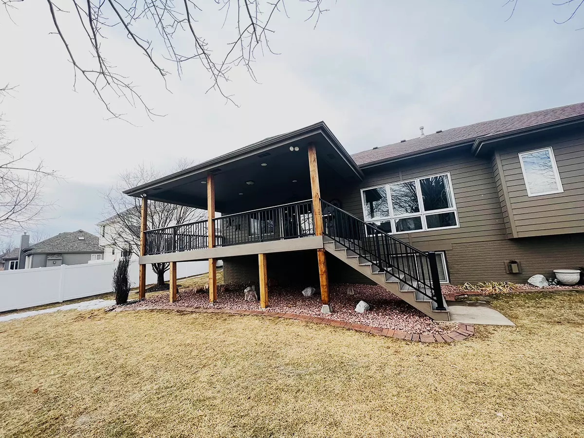 A deck building in Omaha with a composite decking replacement, railing, and new frame