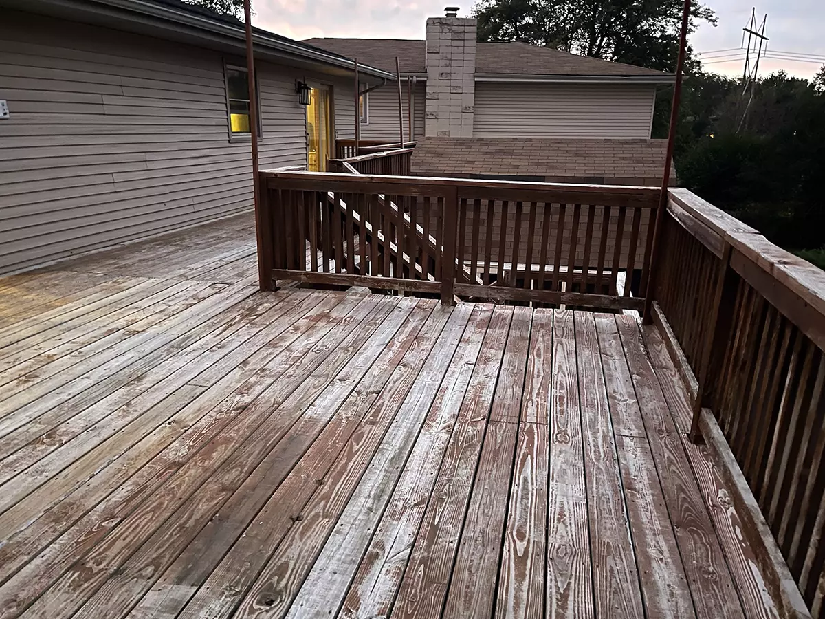 A deck building in Papillon where the wood decking is faded and old