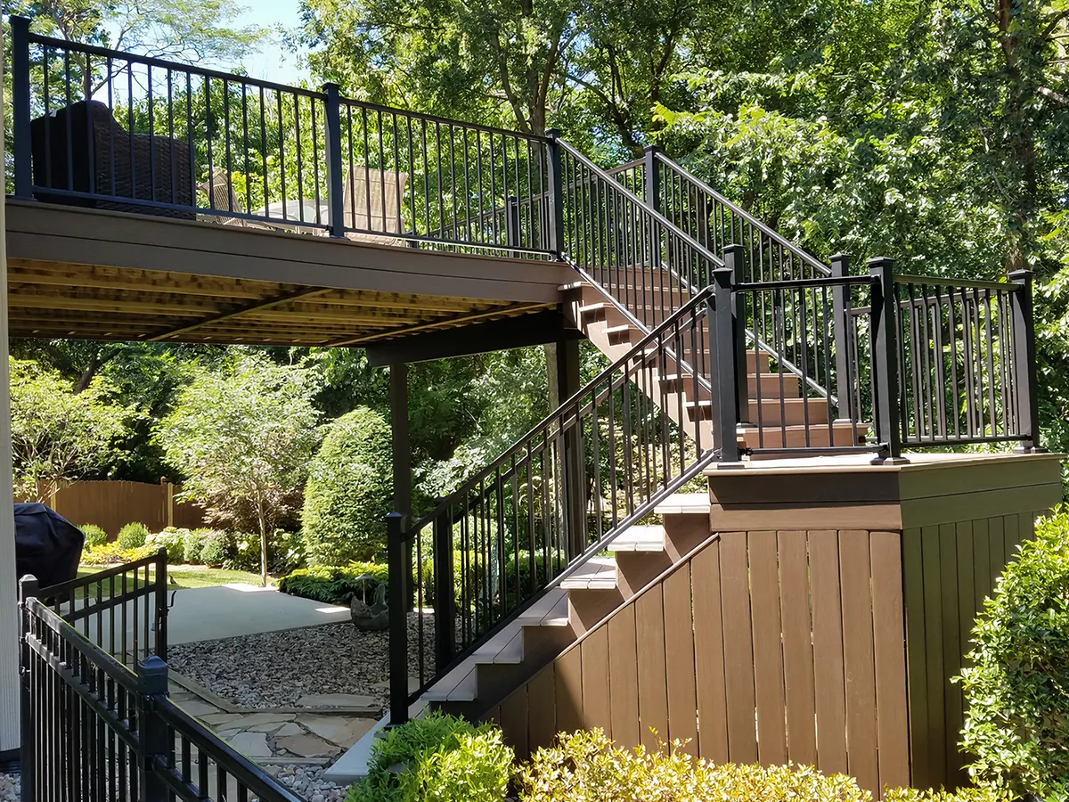 A composite deck with metal railing and two set of stairs
