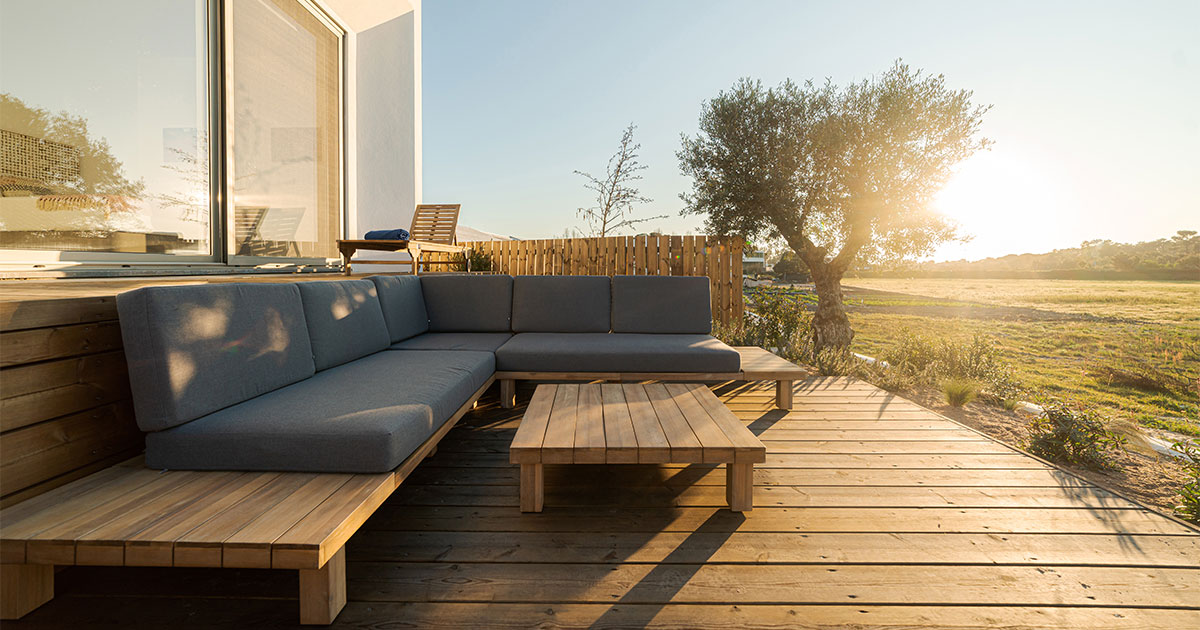 A beautiful sunset with a wood deck and a wood bench