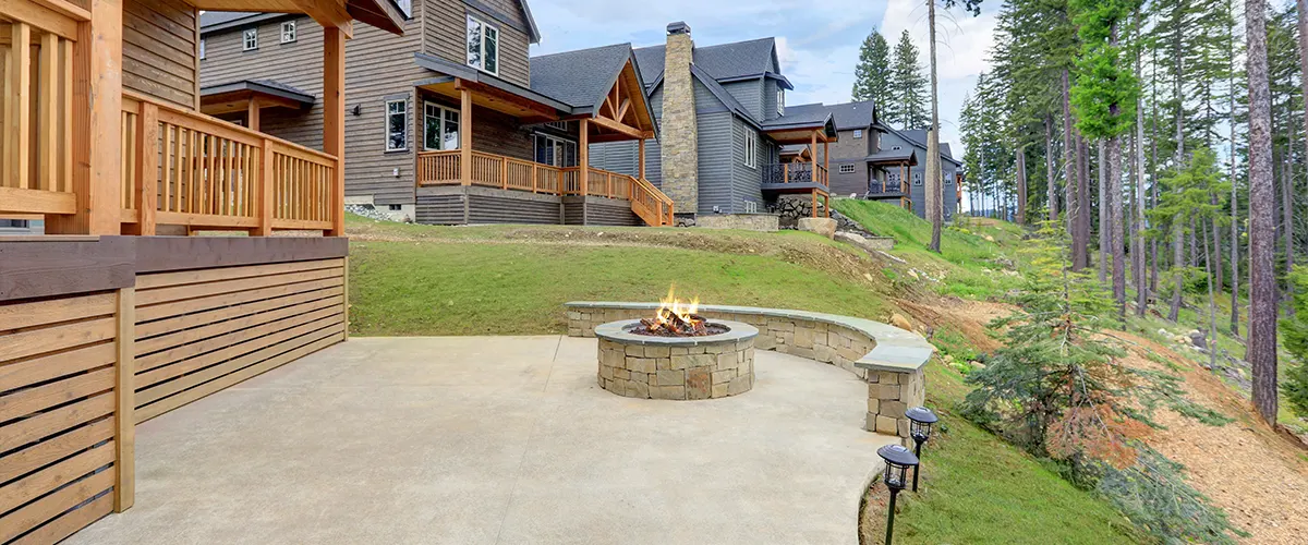 A concrete patio with a fireplace