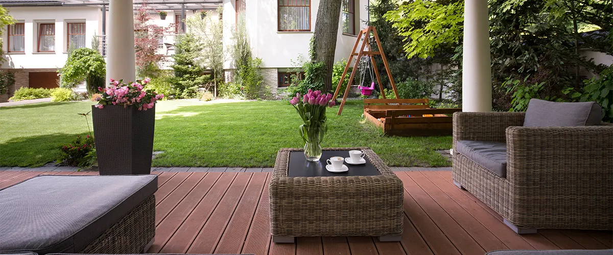 Composite decking on a ground level deck with chairs and tables