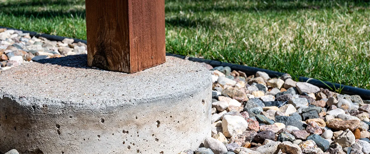 A concrete footing with a piece of lumber