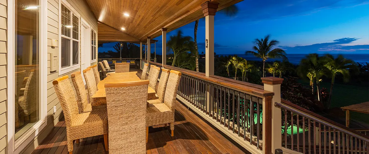 Lighting on an elevated deck with chairs and a table