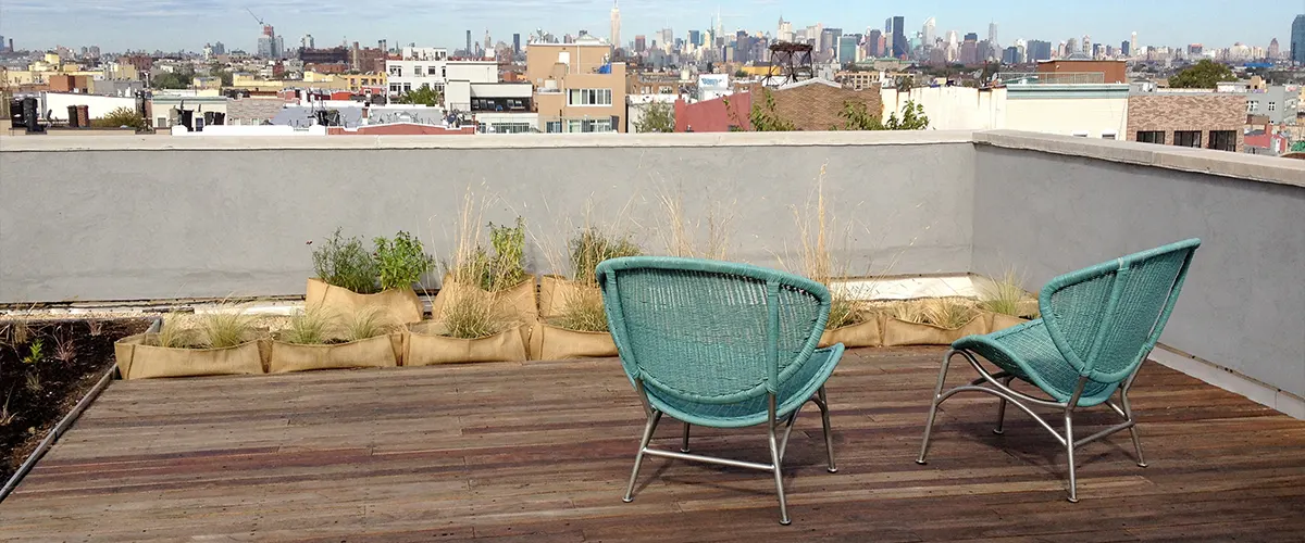 Two blue chairs on a rooftop deck