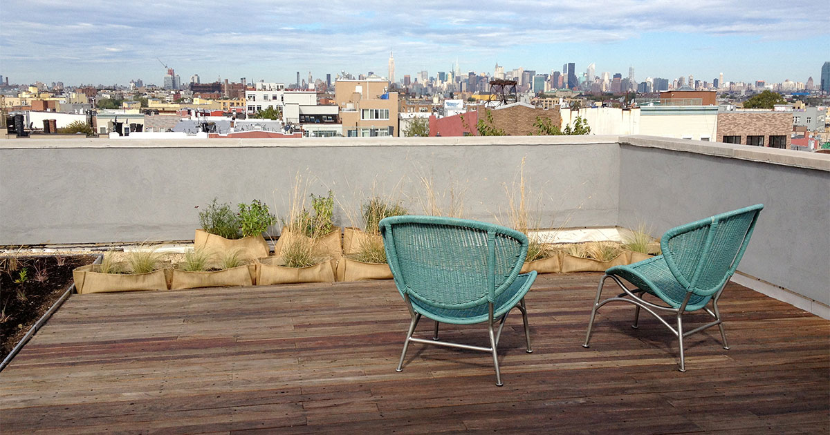 Two chairs on a rooftop deck in suburbs