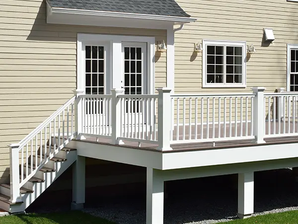 A wood railing painted white on an elevated deck
