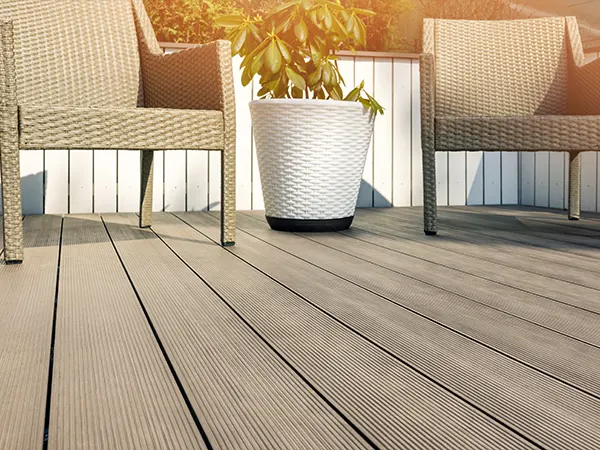A composite decking with two chairs and a plant