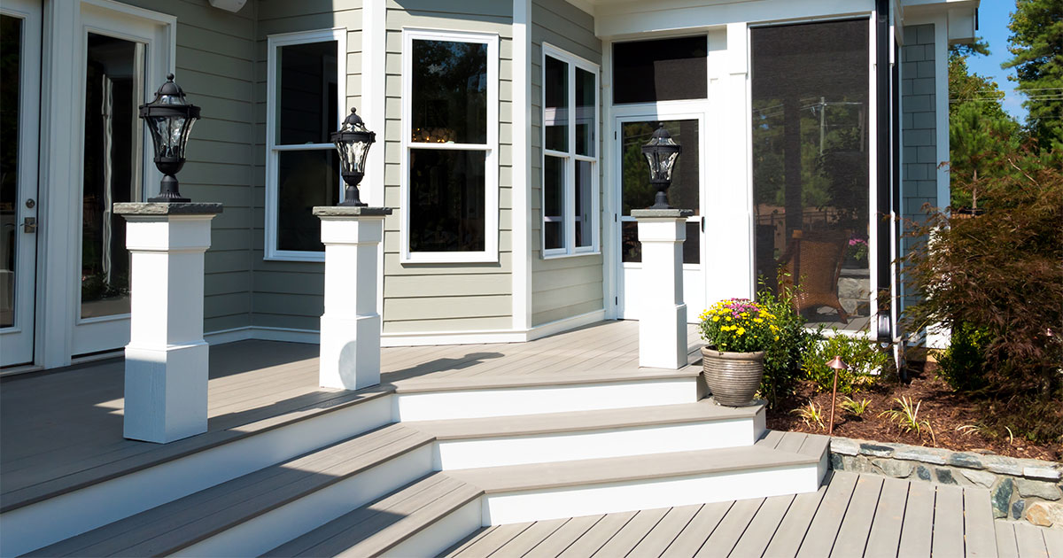 Blog A deck with stairs and lights in front of the house