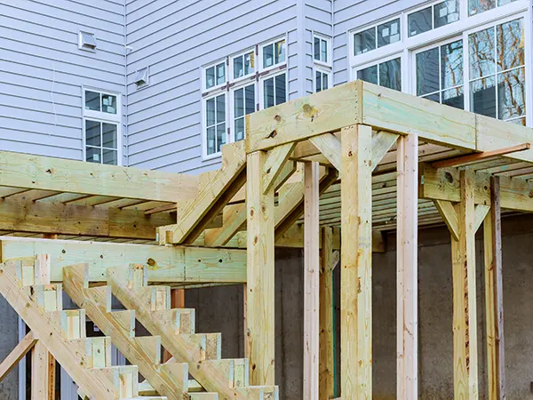 An elevated deck frame with a set of stairs