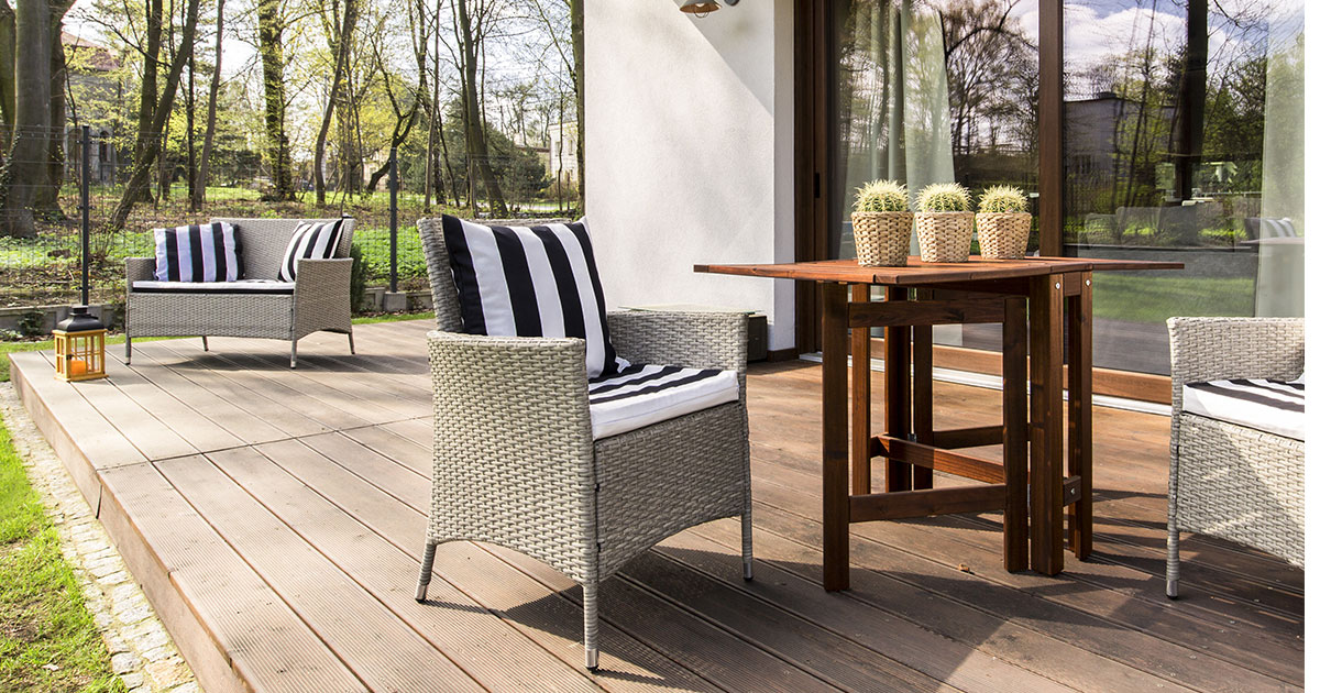 Composite decking on a ground-level deck with chairs and a table