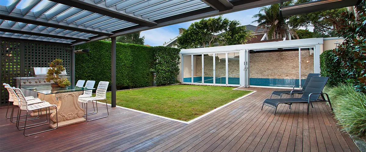 An outdoor kitchen on a large wood deck on the ground