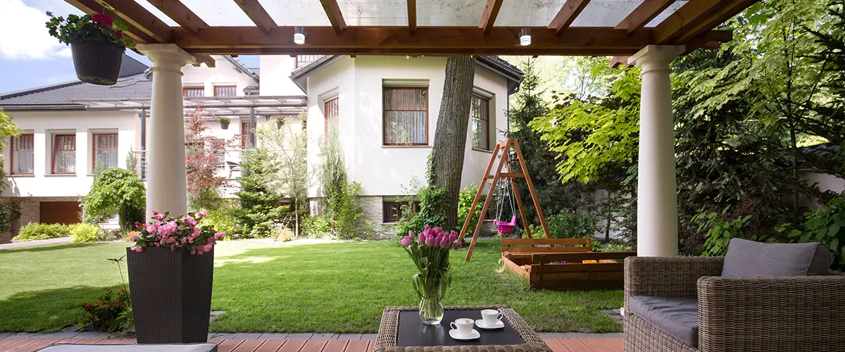 A wood pergola with stone columns