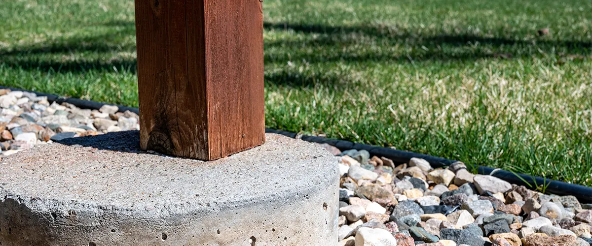 A wood post on a concrete block