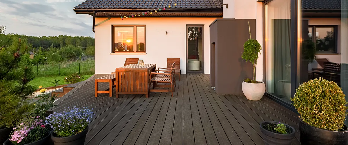 Composite decking and a beige home at dawn