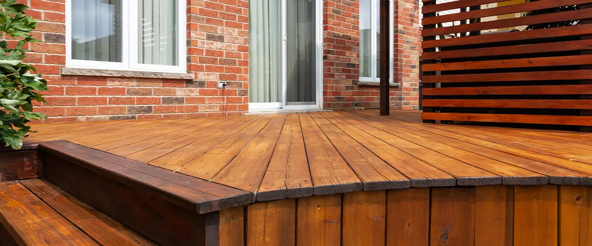 A deck repair cost in Omaha of a wood deck stained in a reddish color