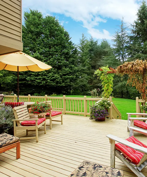 A painted deck with red chairs and a yellow umbrella