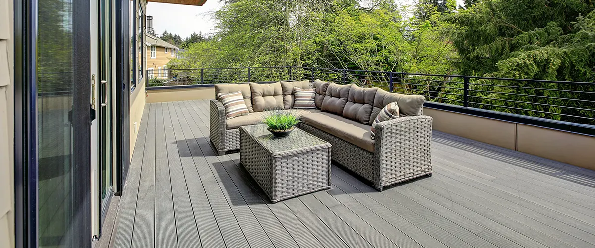 A gray slate decking with furniture made by the best deck builders in Omaha