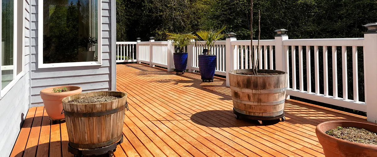 A cedar deck with pots of plants and flowers