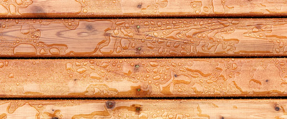 A close-up texture of cedar wood with water droplets on it