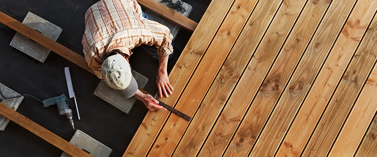 A contractor installing composite decking