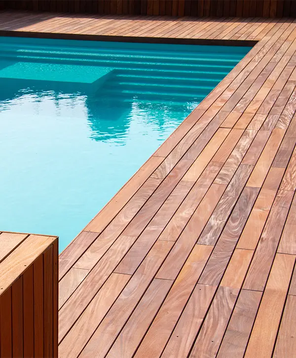 A pool wood deck with built-in bench