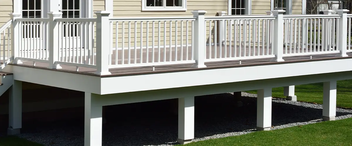 A fascia board on an elevated deck with white railing