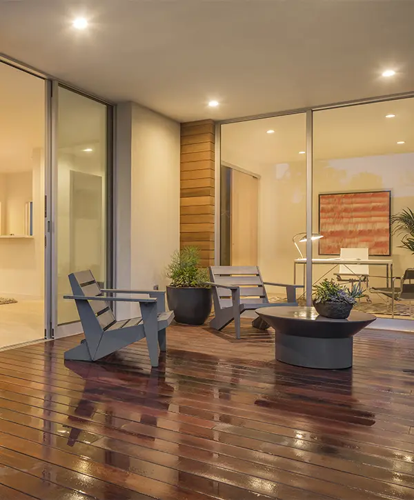 Wood chairs on a wet deck at night