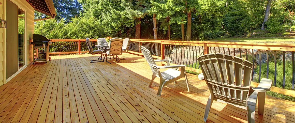 Cedar decking with plastic chairs and railings
