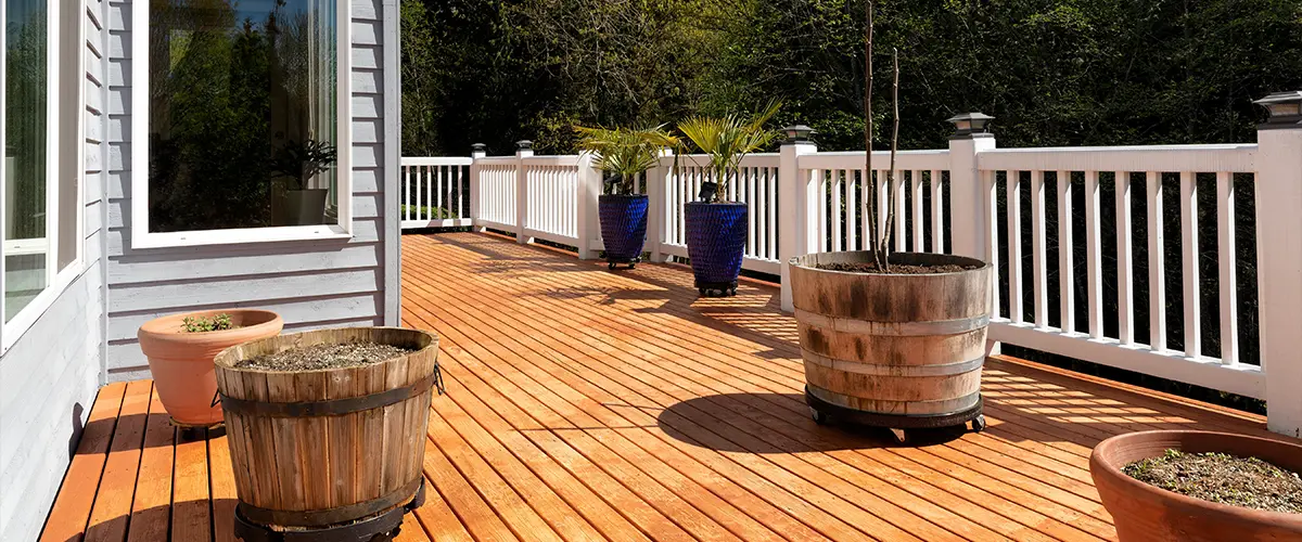Cedar decking with potted plants and white railing
