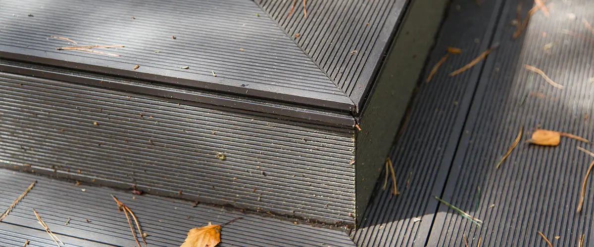 Composite decking step with leaves on it