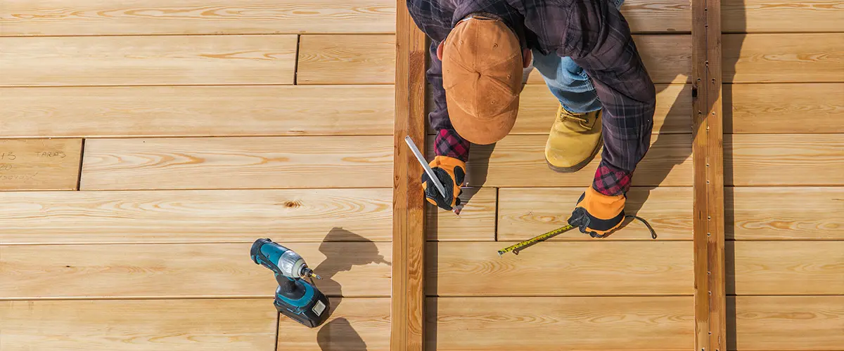 Deck builder installing wood decking