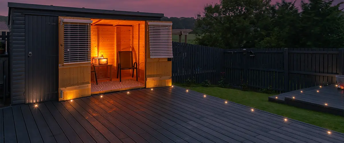 Ground level deck with lights and a shack